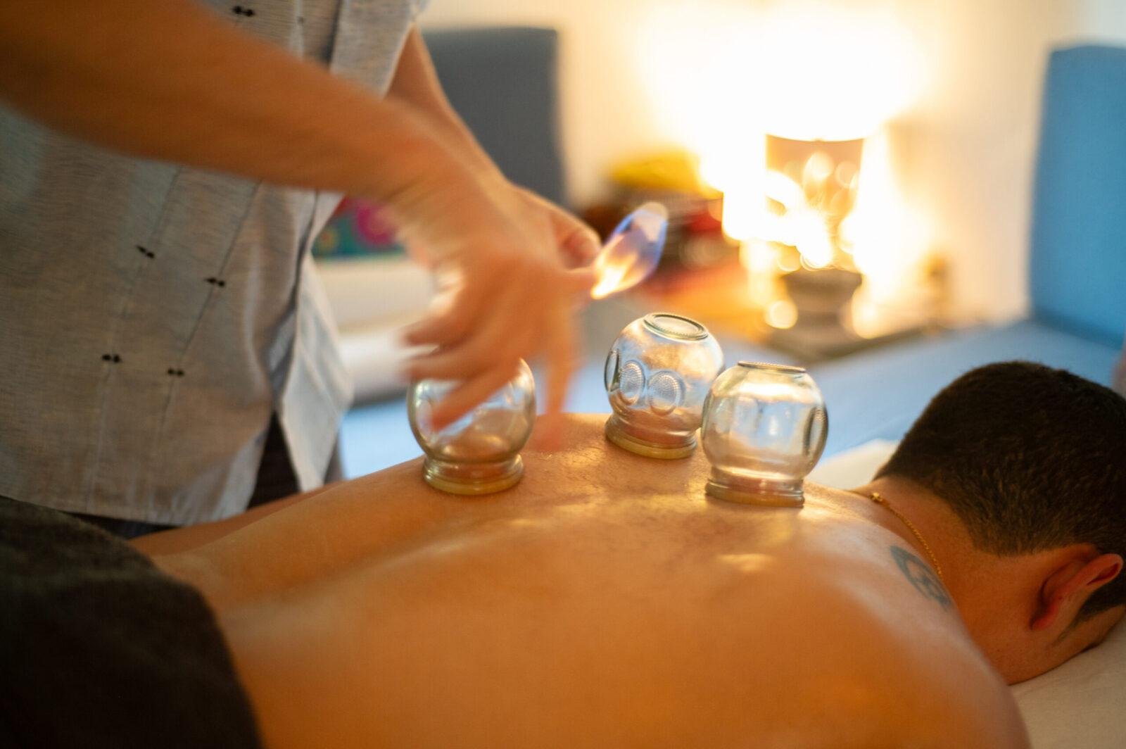 Practitioner-led back cupping support for relaxation and physical tension release at Natoorales Huatulco